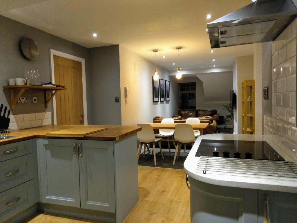 a kitchen with a table and a dining room at Modern Town Apartment with Terrace in West Kirby