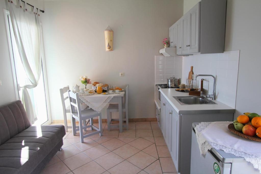 a kitchen with a sink and a table with a tableablish at Romanza Studios in Vasiliki