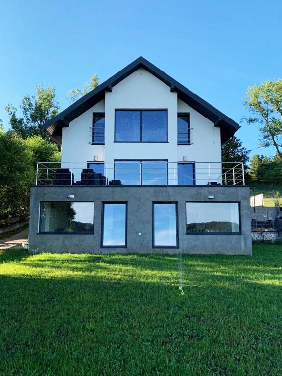a large white house with a lot of windows at Willa Hańcza 1 in Kleszczówek
