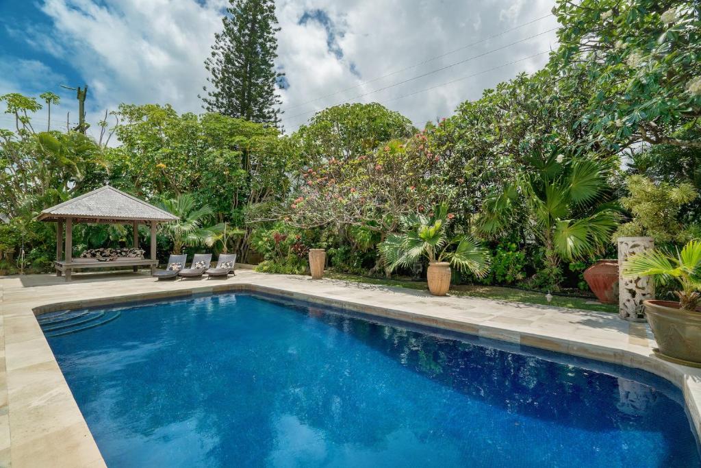 a swimming pool in a yard with a gazebo at Kailua Beachside home in Kailua