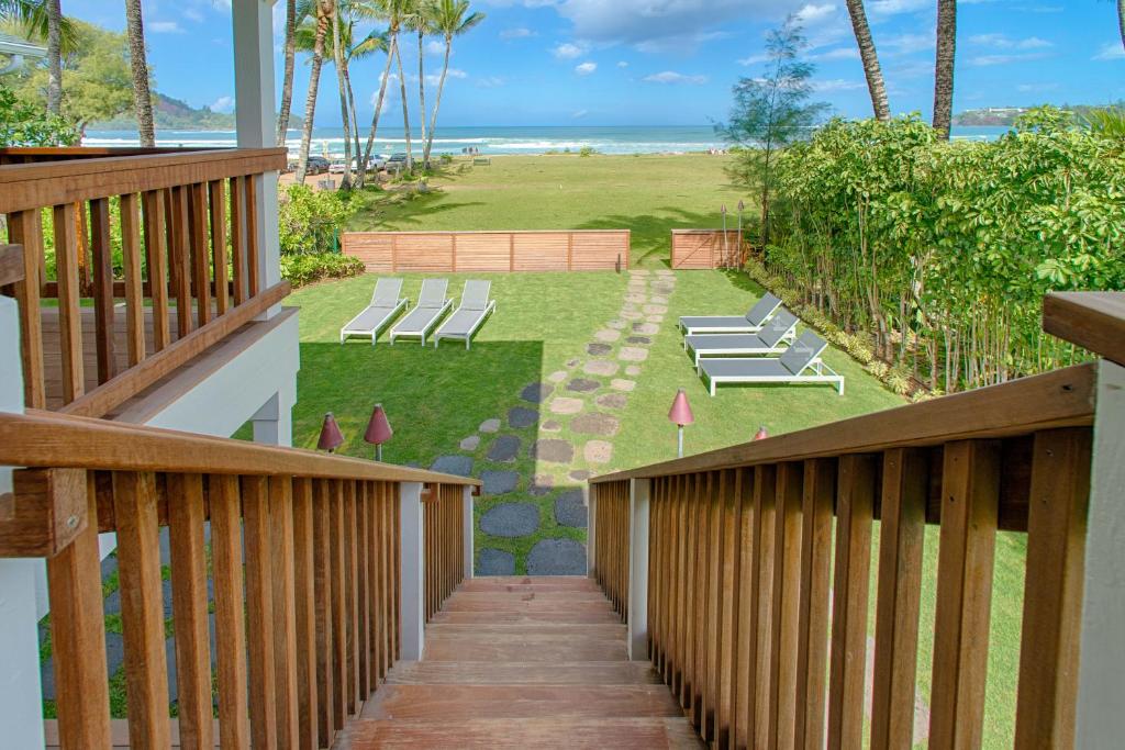 a deck with a view of the beach from a house at Hanalei Beach House Estate home in Hanalei