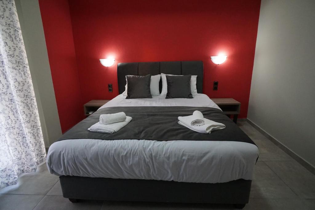 1 dormitorio con 1 cama grande y paredes rojas en Studio Maggana en Mángana