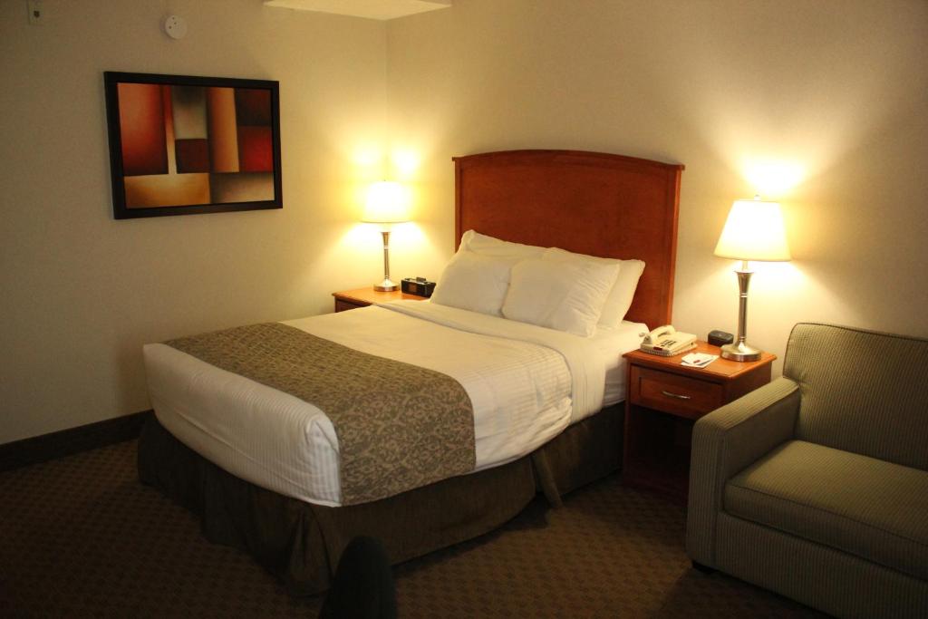 Postel nebo postele na pokoji v ubytování Ramada by Wyndham Edmonton South