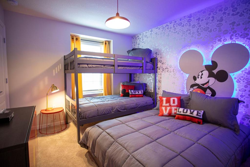 a bedroom with a mickey mouse mural on the wall at Windsor at Westside in Kissimmee