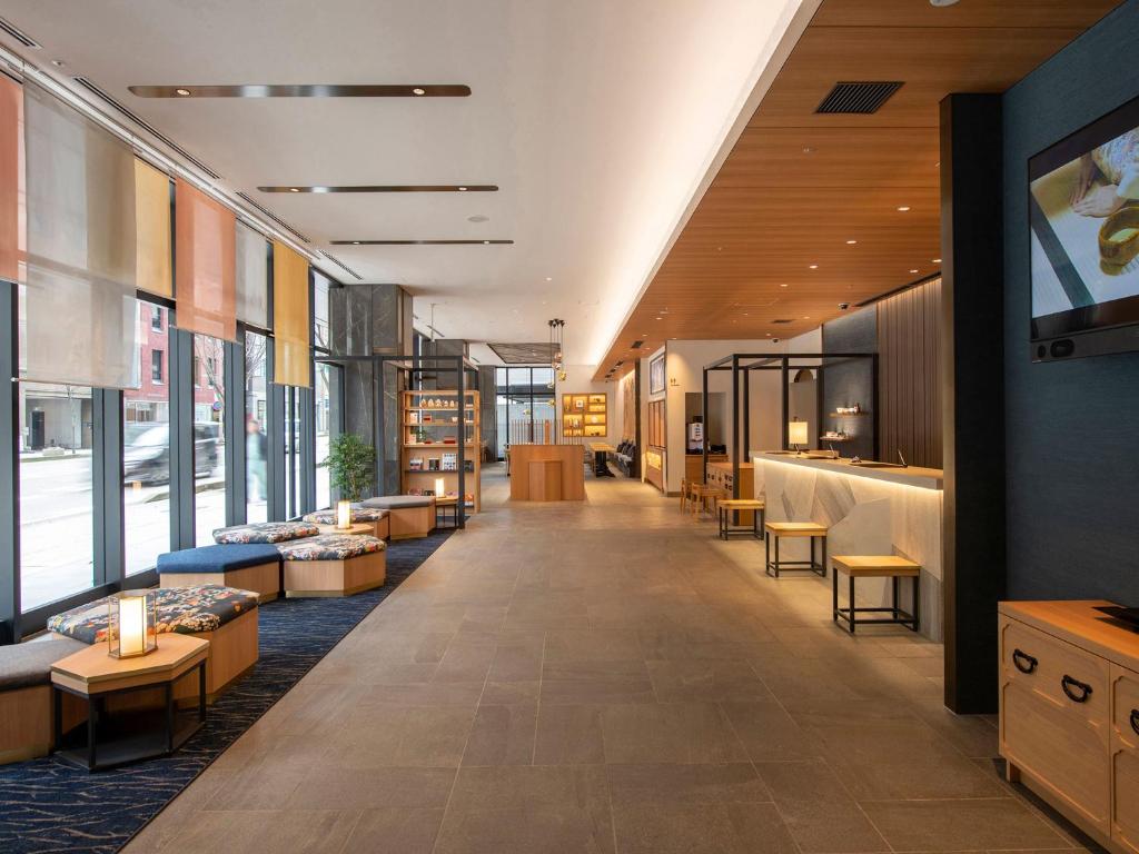a lobby of a store with tables and chairs at Tokyu Stay Kanazawa in Kanazawa