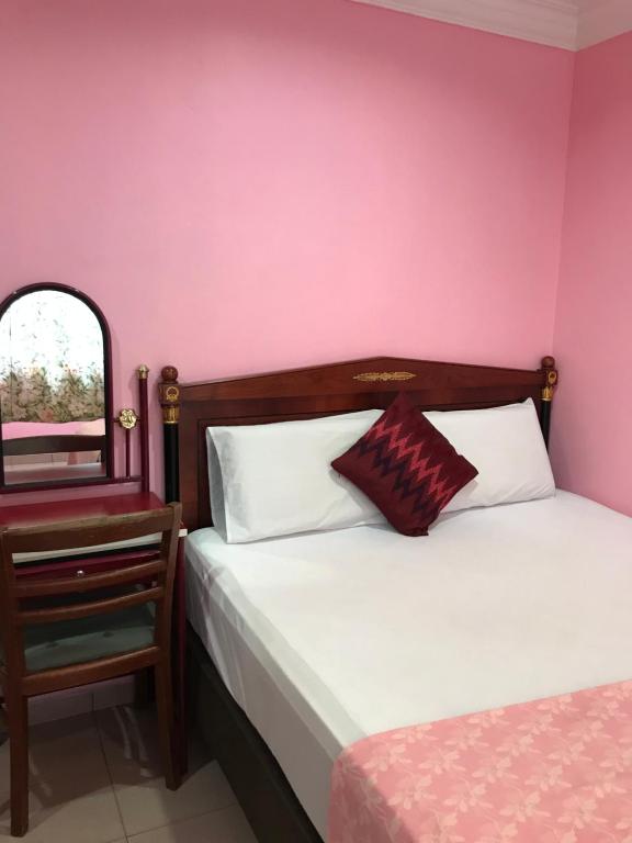 Postel nebo postele na pokoji v ubytování Hotel Cahaya