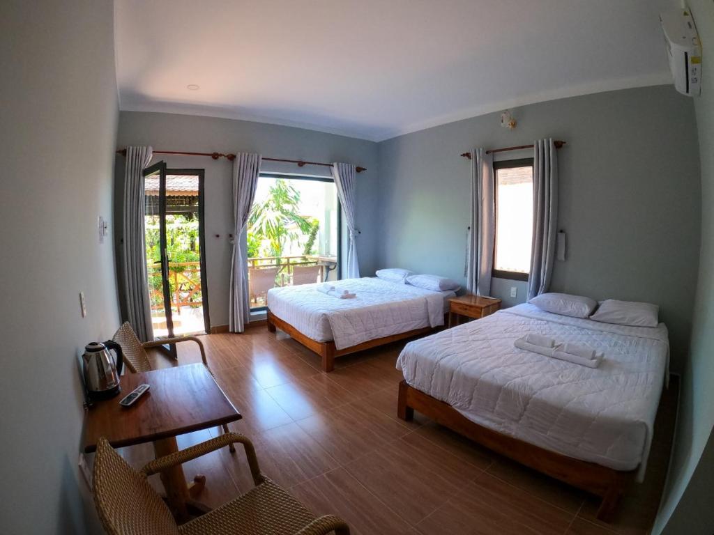 Giường trong phòng chung tại Phu Quoc Areca Garden Bungalow