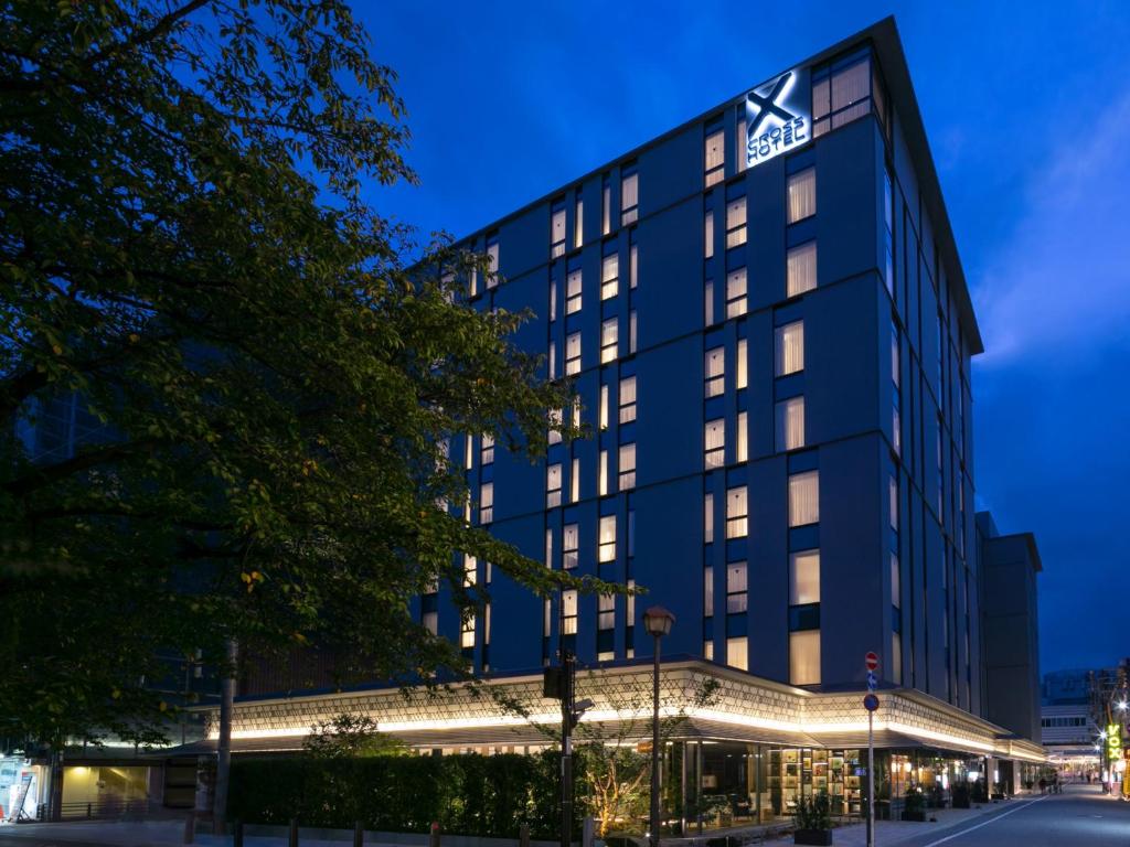 an exterior view of the hotel at night at Cross Hotel Kyoto in Kyoto