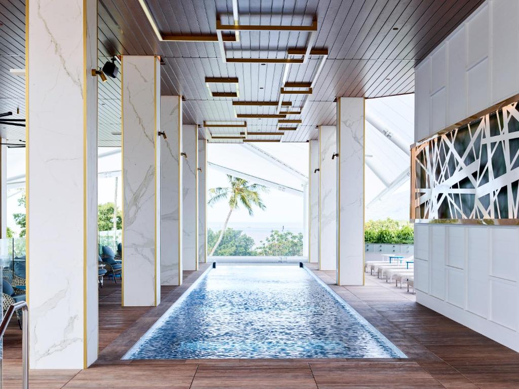 a swimming pool in the middle of a building at Crystalbrook Flynn in Cairns