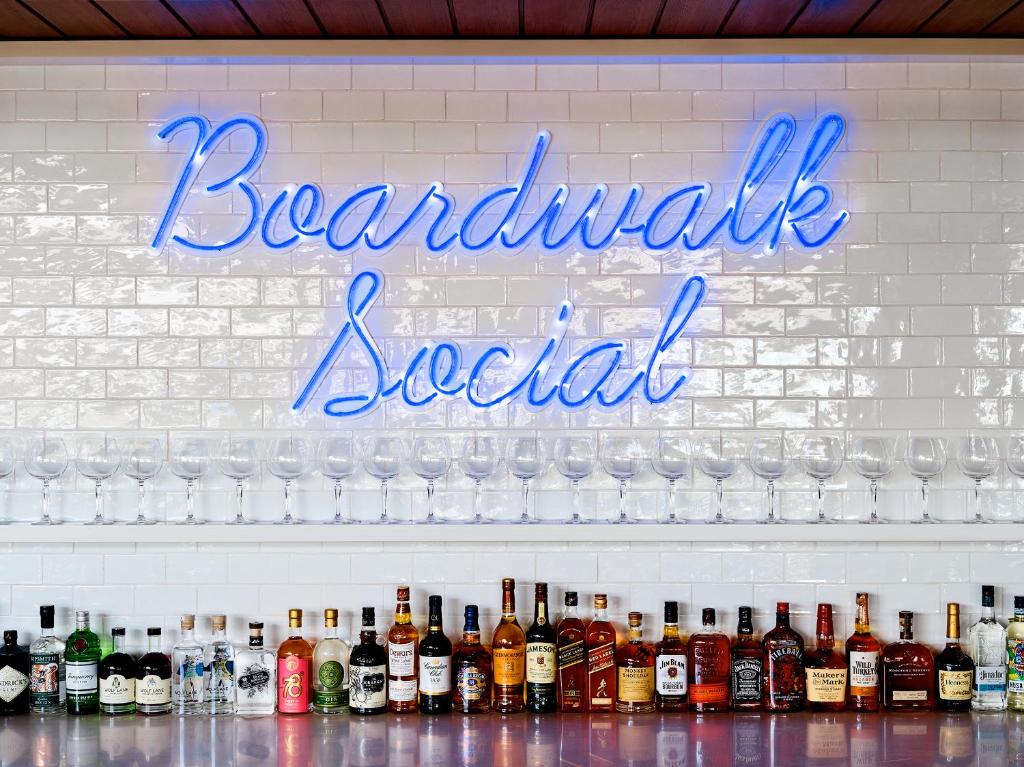 a sign for a bar with bottles of alcohol at Crystalbrook Flynn in Cairns