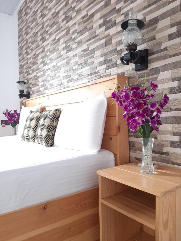 Postel nebo postele na pokoji v ubytování Dhanudi Homestay