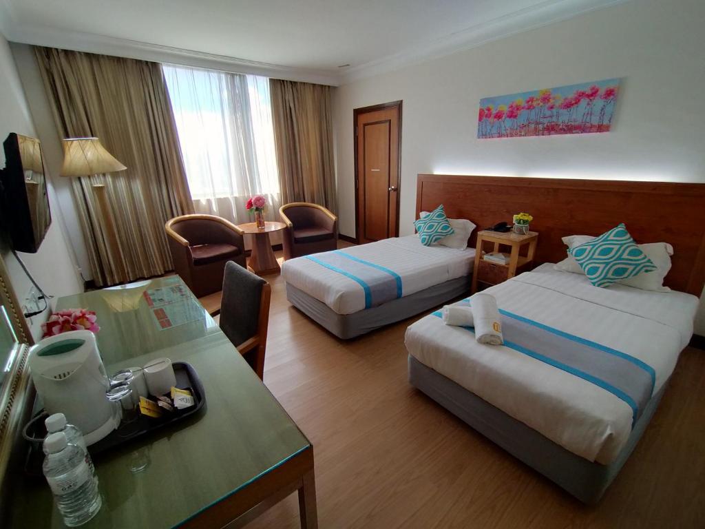 Postel nebo postele na pokoji v ubytování Tang Dynasty Hotel