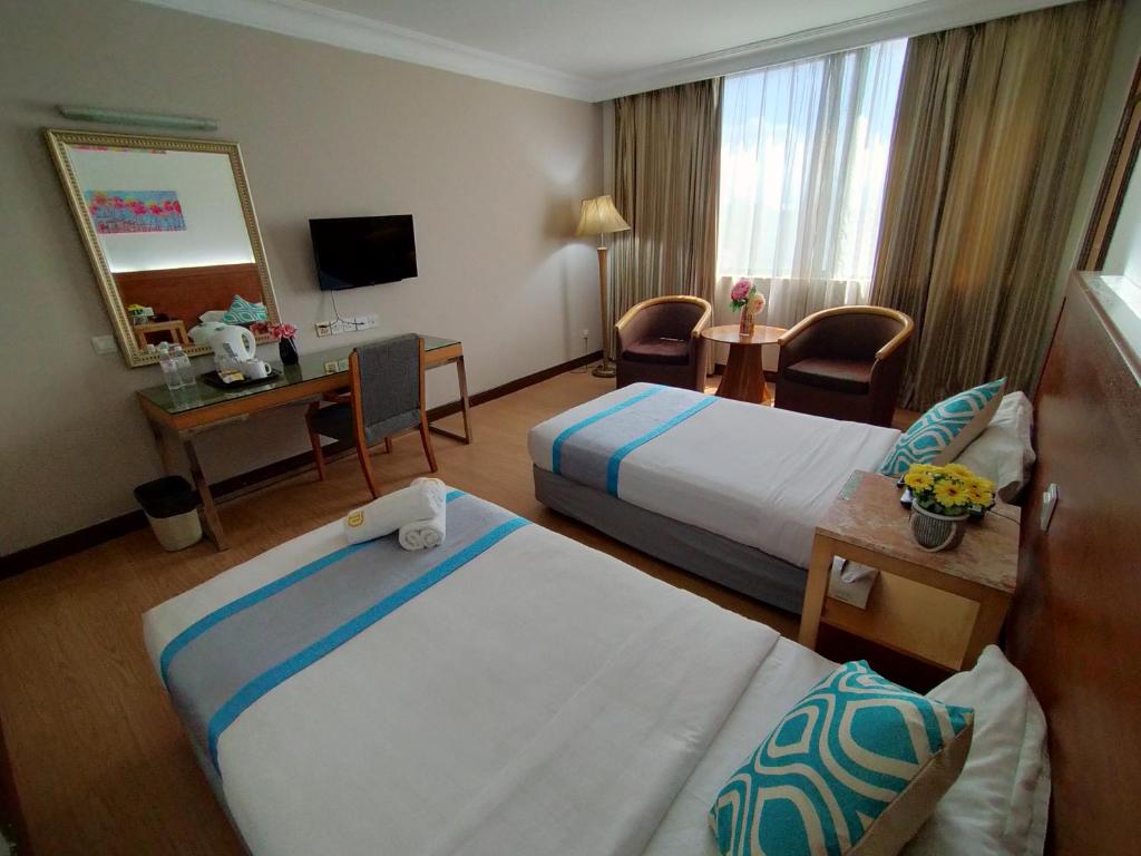 Postel nebo postele na pokoji v ubytování Tang Dynasty Hotel