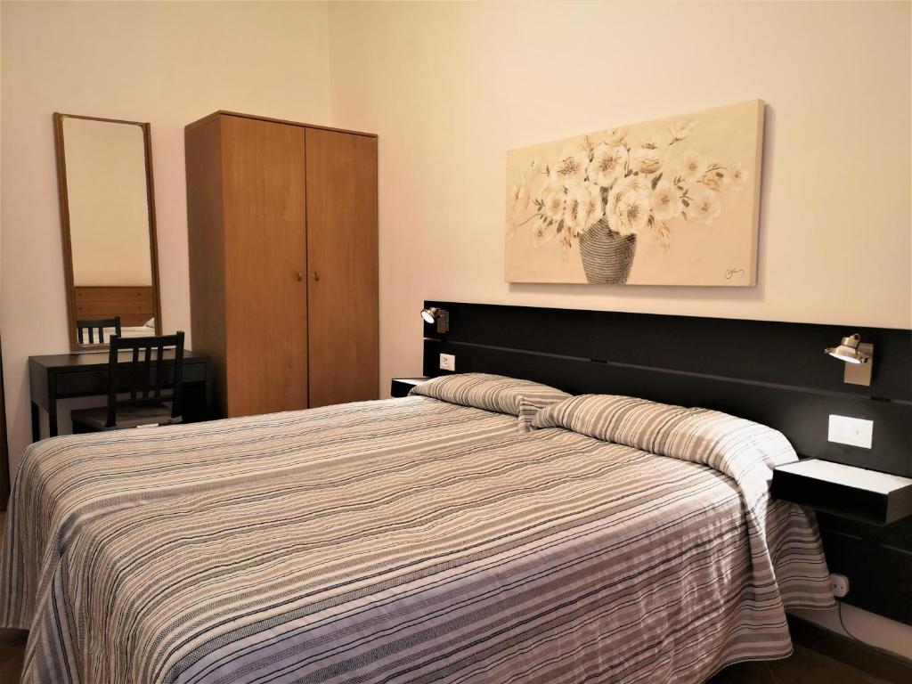 Postel nebo postele na pokoji v ubytování Hotel Rossi