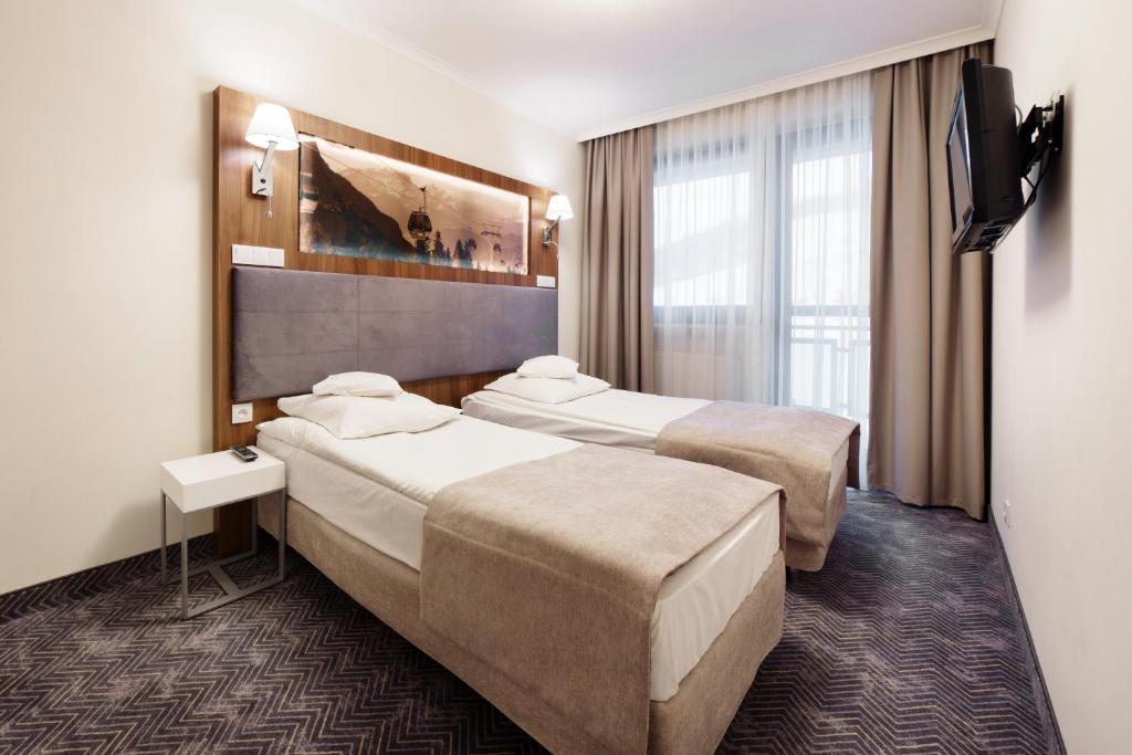 Posteľ alebo postele v izbe v ubytovaní Hotel Pegaz