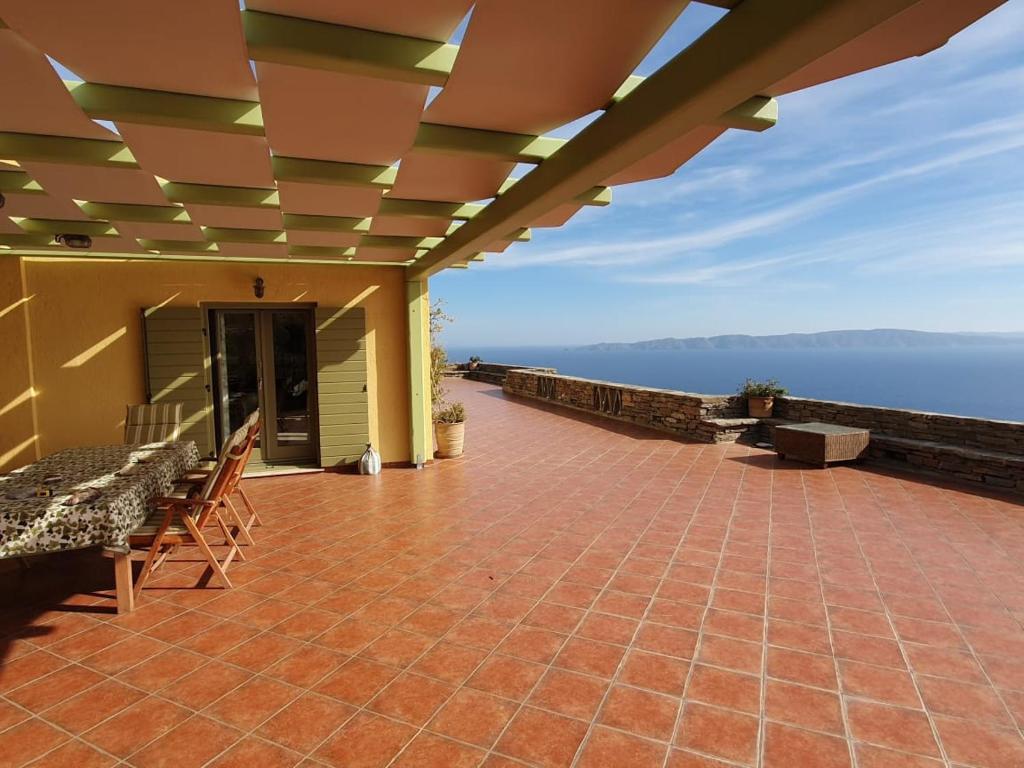a large patio with a view of the ocean at Breathtaking seaview villa in a serene scenery in Chavouna