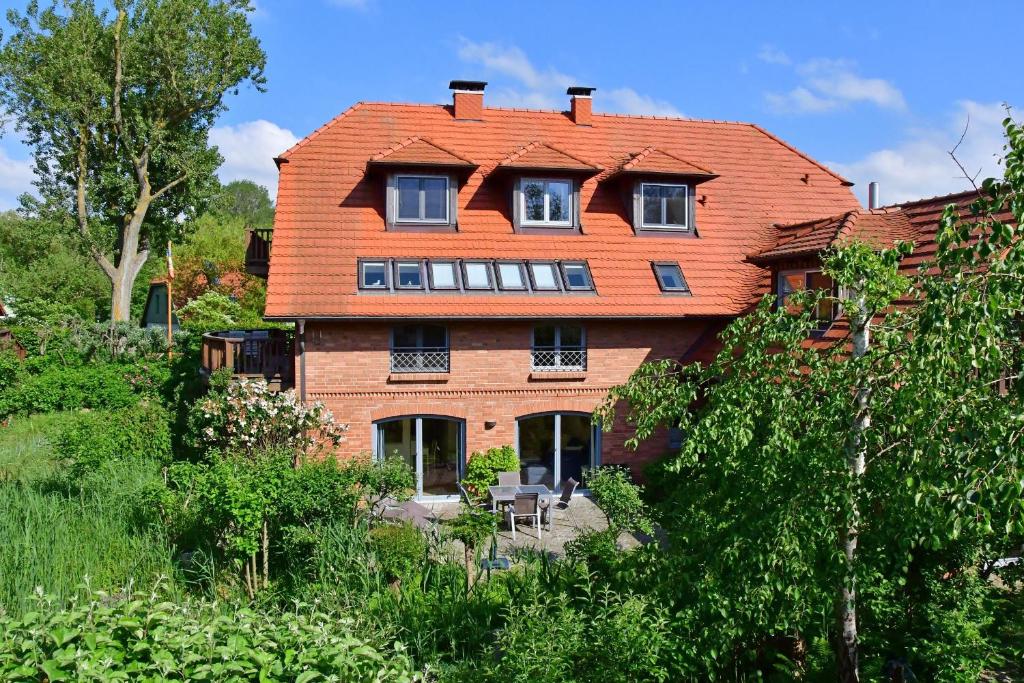 a large house with an orange roof at Dünenhof DÜNENHOF Whg. D-02 in Wustrow