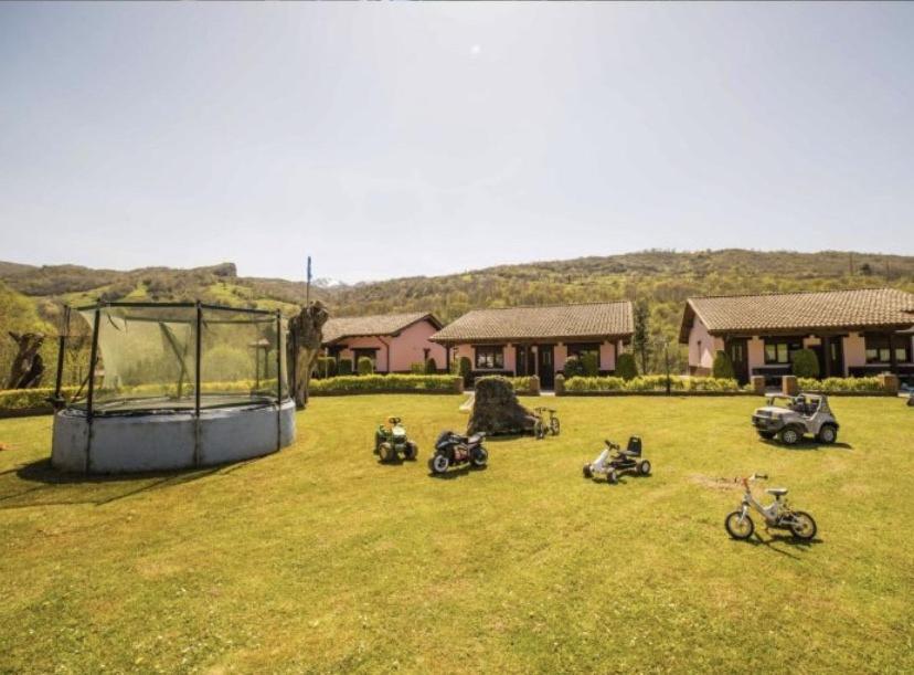 a group of motorcycles parked in a grass field at Apartamentos Aires De Avin - Onis in Avín