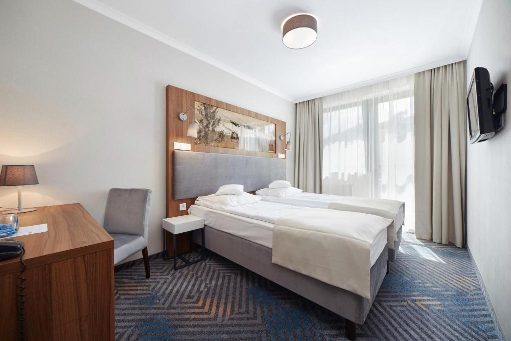 Posteľ alebo postele v izbe v ubytovaní Hotel Pegaz