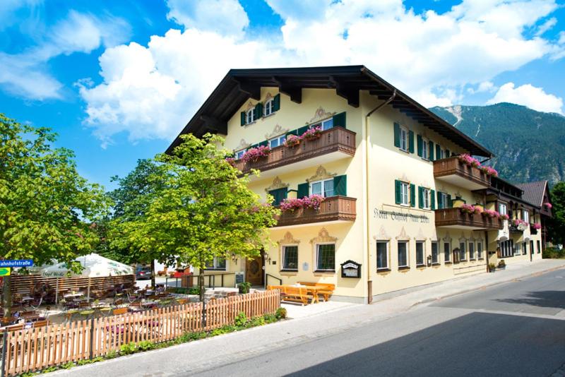 a building on the side of a street at Hotel Gasthof Alter Wirt in Farchant