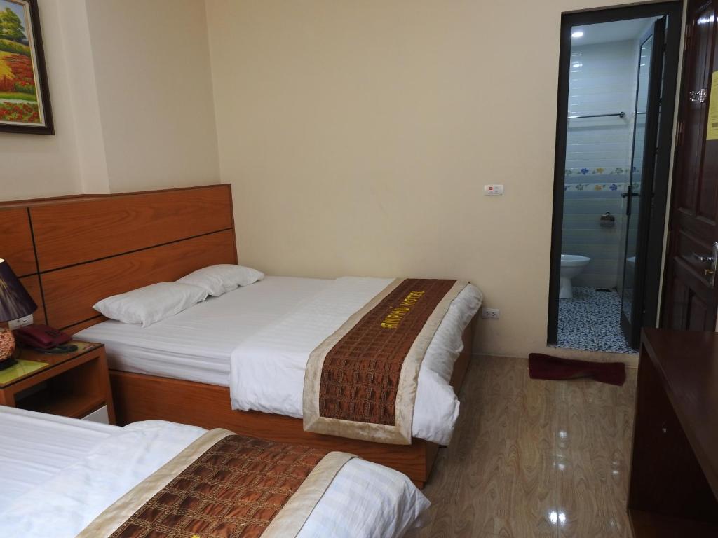 Postel nebo postele na pokoji v ubytování An Phú Nguyễn Hoàng Hotel