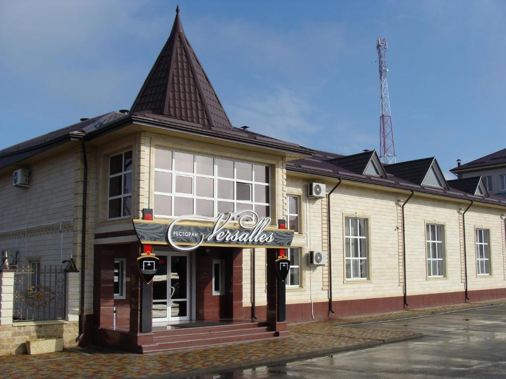 a building with a cocacola sign in front of it at Versal Hotel in Maykop