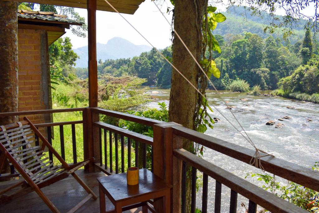 a porch with a view of the river at Rafters Retreat in Kitulgala