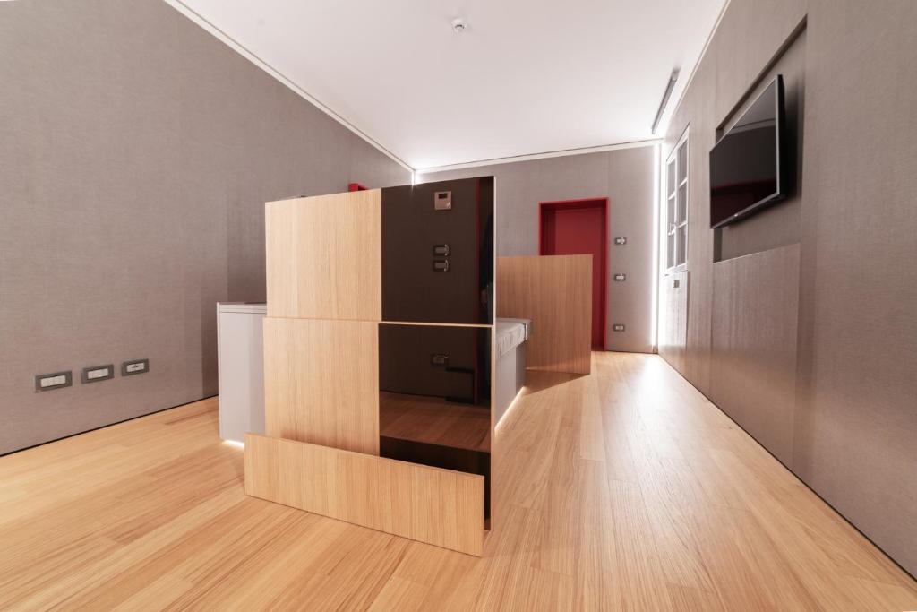 a room with a black refrigerator and cardboard boxes at CaToo Dimora Di Design in Palazzo Nobiliare al Duomo in Padova