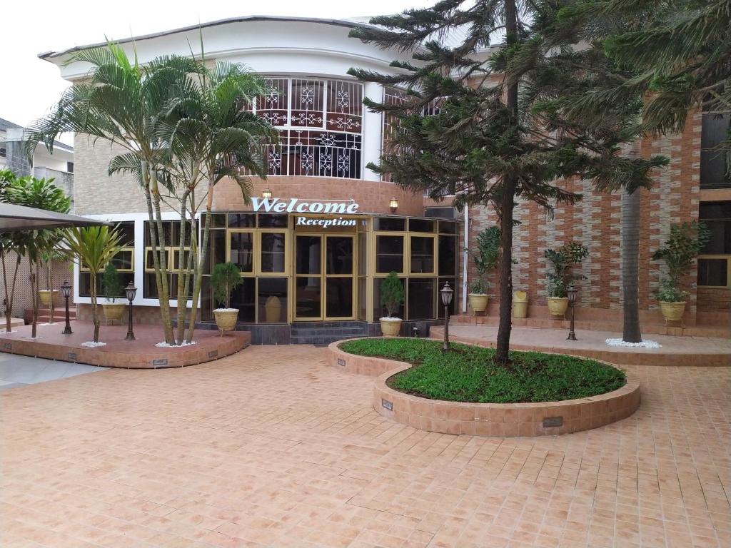 a building with palm trees in front of it at Presken Hotels @ Freedom Way, Lekki in Lekki