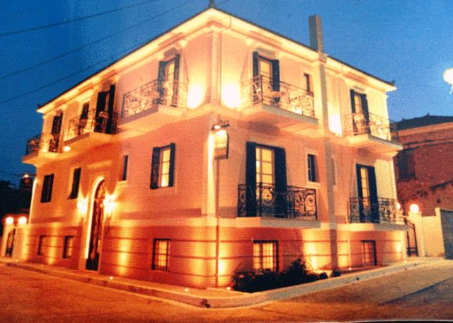 a white building with lights on the side of it at Villa Ianthia in Galaxidi