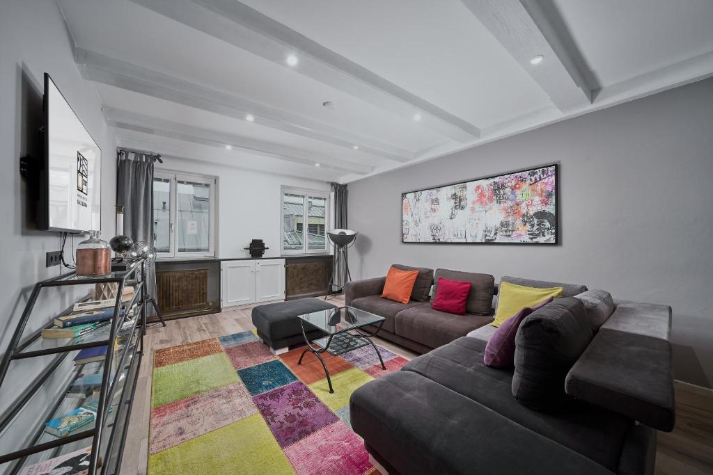 a living room with a couch and a table at Salzburg Apartments in Salzburg