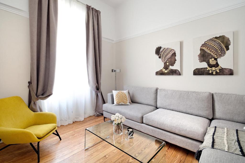 uma sala de estar com um sofá e uma mesa de vidro em Acropolis Memories em Atenas