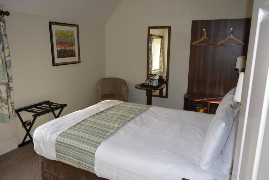 Postel nebo postele na pokoji v ubytování Quorn Grange Hotel