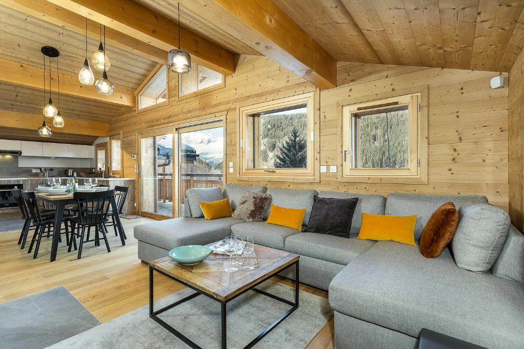 a living room with a couch and a table at APARTMENT TRABETS 2 - Alpes Travel - LES HOUCHES - sleeps 8 in Les Houches