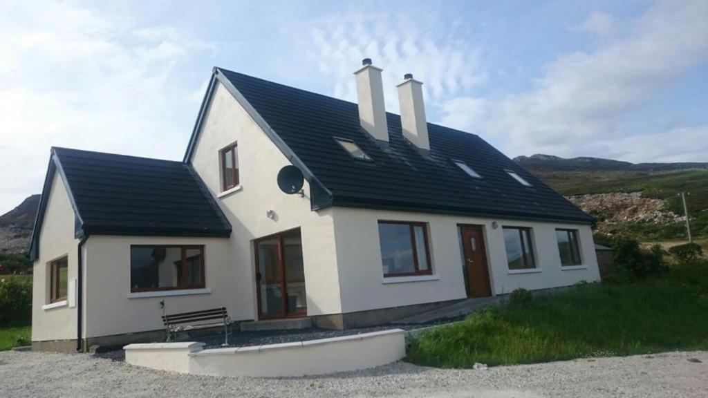 a white house with a black roof at Achill Alantic Dream in Derreen