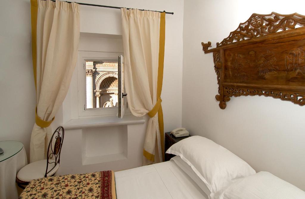 Postel nebo postele na pokoji v ubytování Hotel Fontana