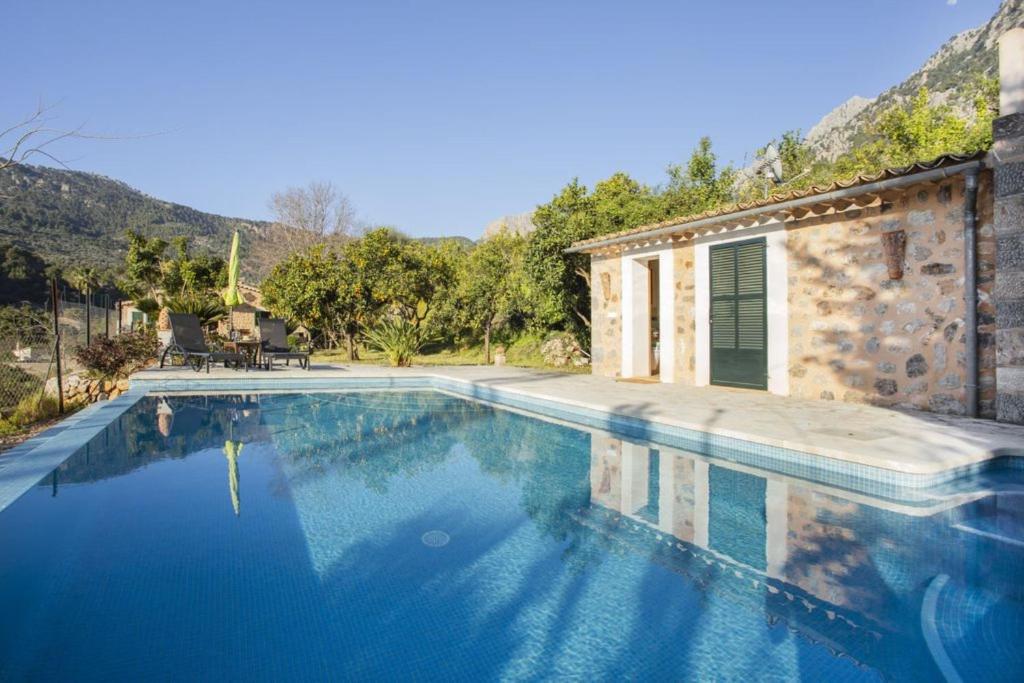 a swimming pool in front of a house at Es Tarongers in Sóller