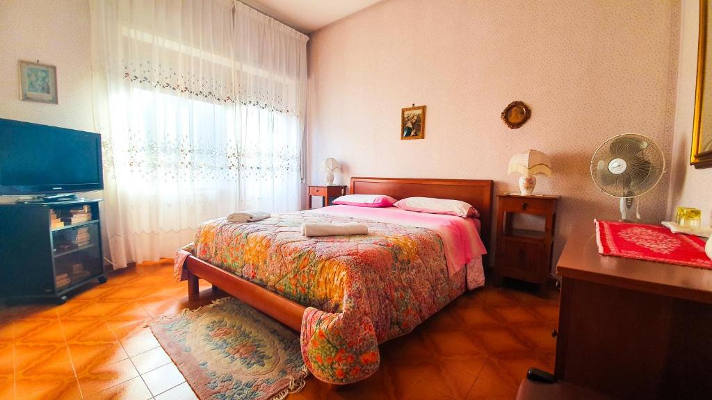 a bedroom with a bed and a large window at Bed and breakfast Giuseppina in Rome