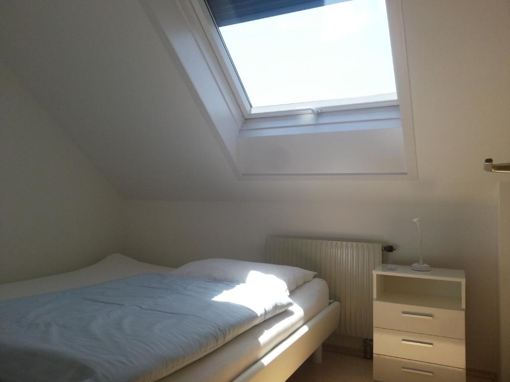 a small bedroom with a bed and a skylight at Appartement Feldkirch in Feldkirch
