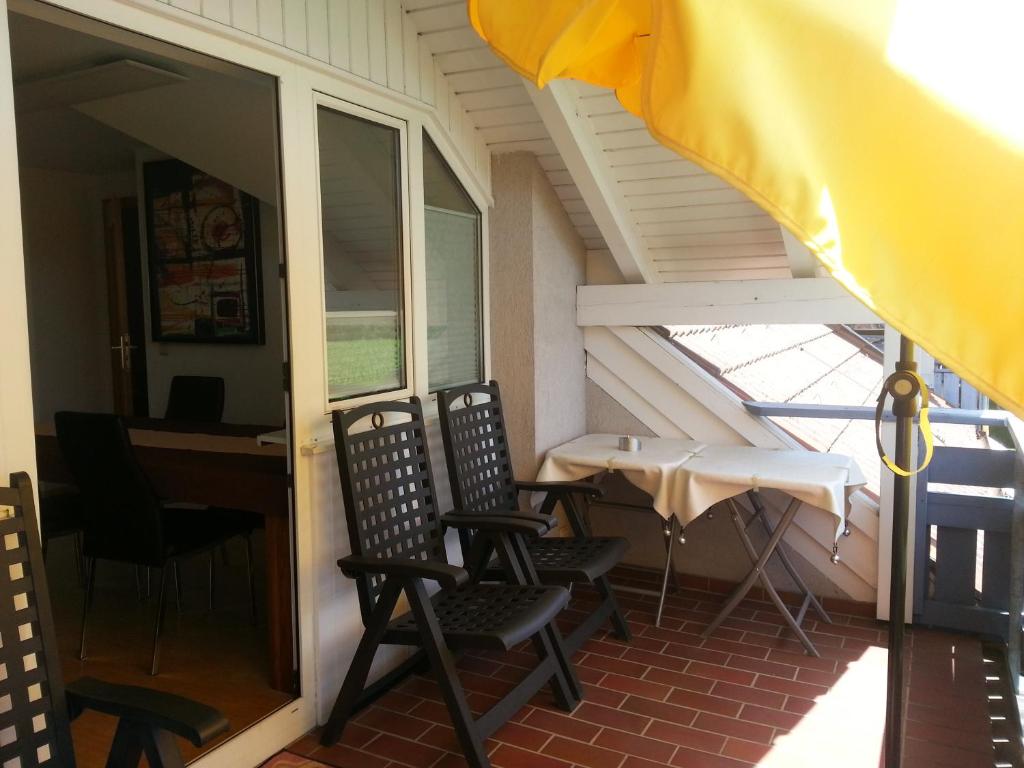 a screened in porch with chairs and a table at Appartement Feldkirch in Feldkirch