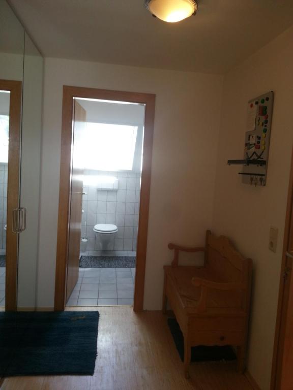 a bathroom with a toilet and a sink and a door at Appartement Feldkirch in Feldkirch