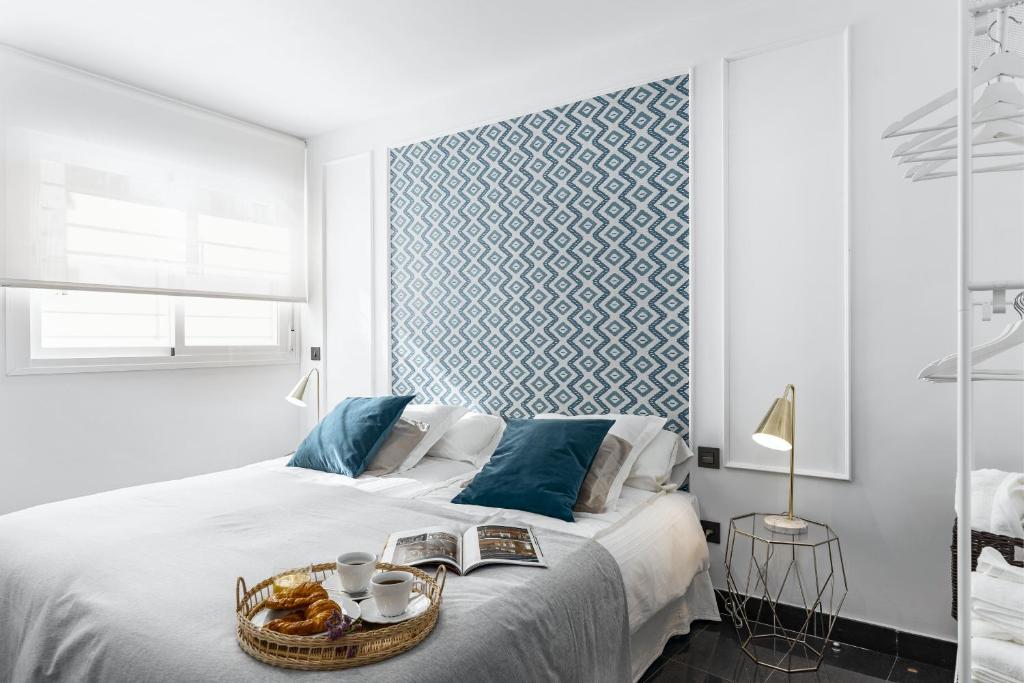 a bedroom with a bed with a basket of food on it at Apartamento Pedregalejo Beach Playa in Málaga