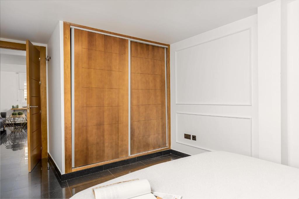 A bed or beds in a room at Apartamentos Pedregalejo Beach Playa