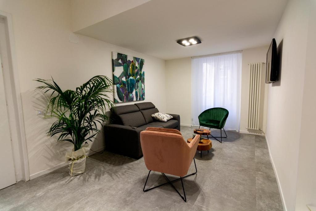 een woonkamer met een bank en een plant bij Dadà House in Catania