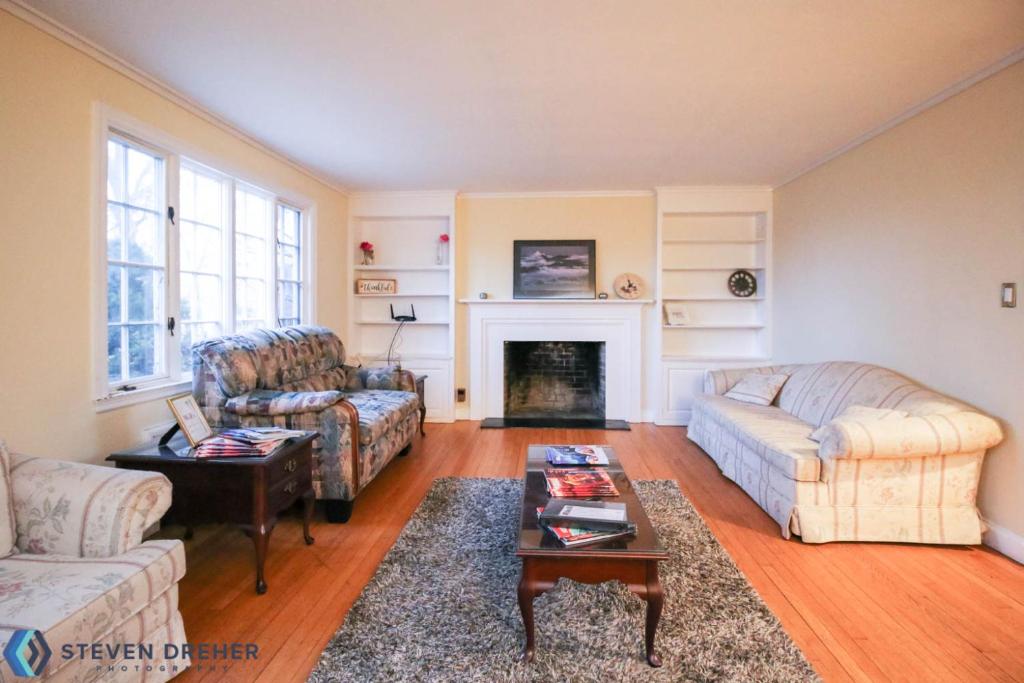 a living room with two couches and a fireplace at Town Plot Waterbury in Waterbury
