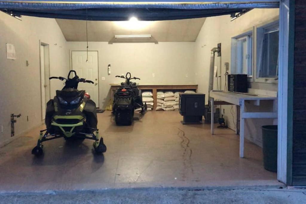 a garage with two motorcycles parked in it at Stone Haven Inn in Valemount