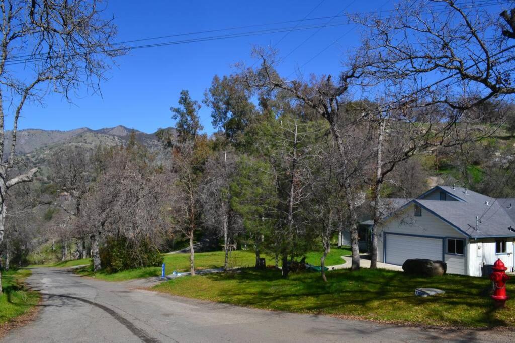 a house with a red fire hydrant on the side of a road at Blue Jay Paradise in Three Rivers