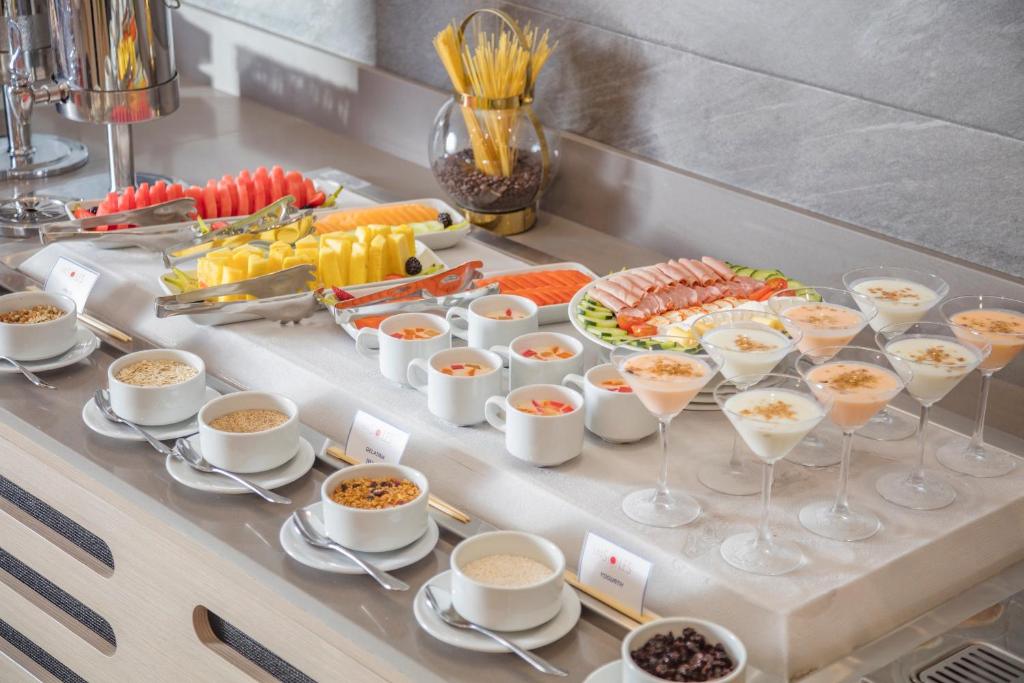 a buffet of food and drinks on a table at Holiday Inn & Suites - Aguascalientes by IHG in Aguascalientes