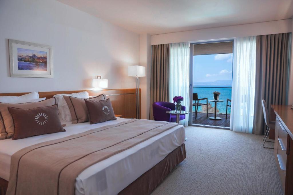 a hotel room with a bed with a view of the ocean at ON'LIVE HOTEL in Çeşme