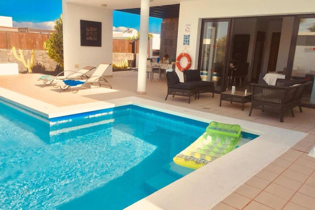 a swimming pool with a raft in the middle of a house at Casa Vilas in Playa Blanca